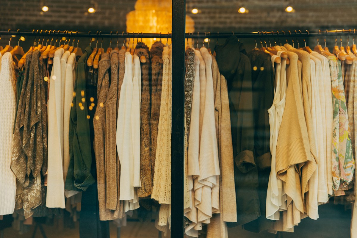 A rail of soft-toned clothing in a boutique