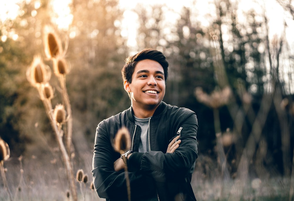 Portrait of a young man in a bomber jacket in soft golden-hour light